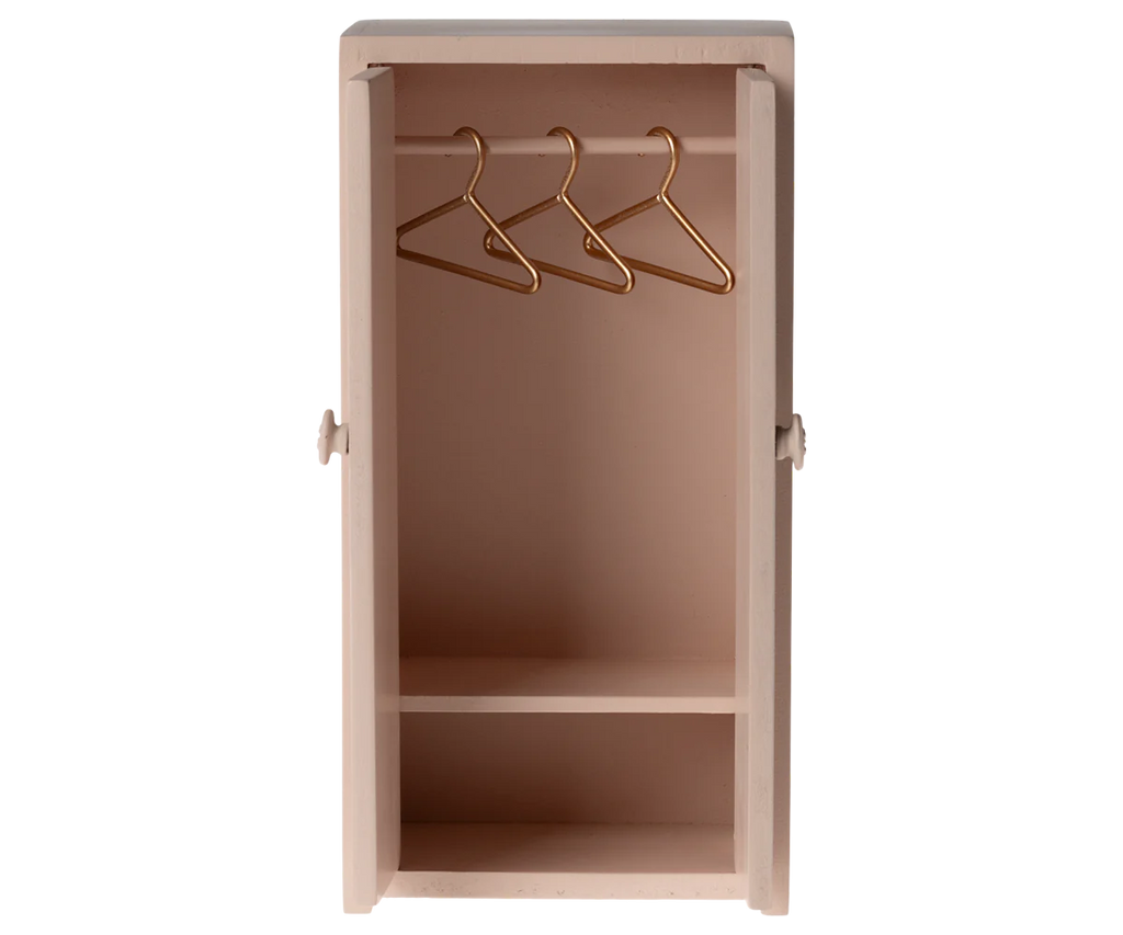 A cute, light rose Maileg Mouse Closet with open doors reveals a charming space for a mice family. Inside, three golden hangers gleam on the top rod above an empty shelf, ideal for displaying a children's toy collection. Ships in approximately one week.