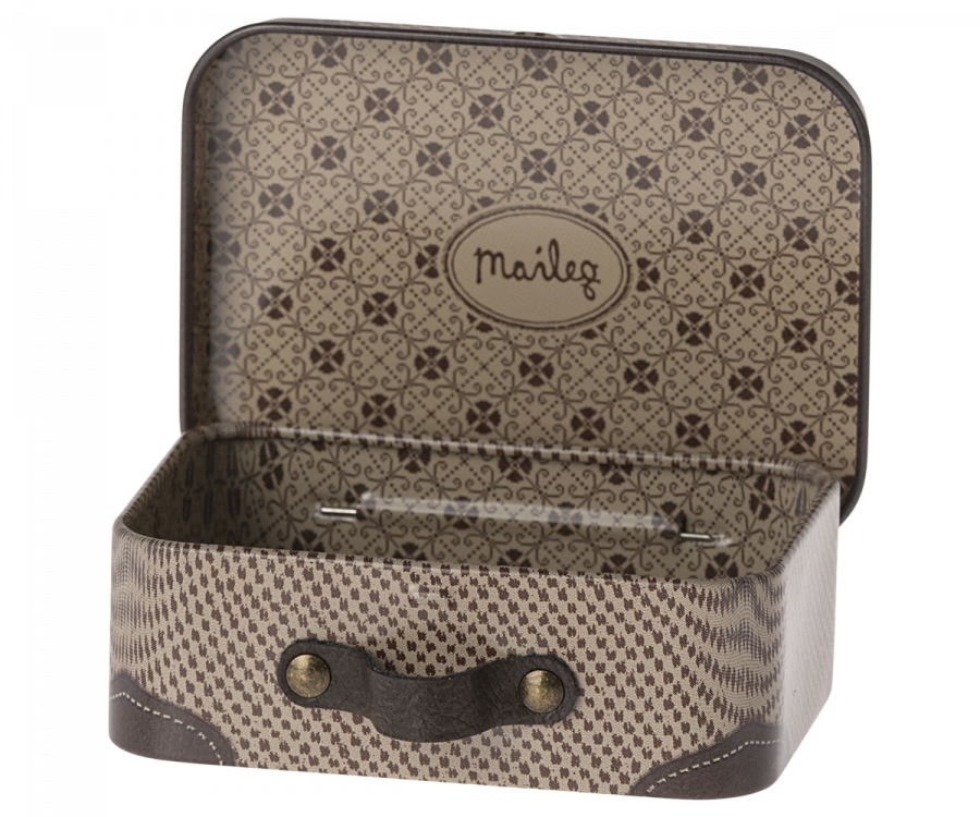 The Maileg Suitcase, Micro is a small metal suitcase beautifully decorated with a brown pattern on both the interior and exterior. Inside, it features an oval label with the word "Maileg," surrounded by colorful illustrations. The handle is embellished with brass studs, adding to its charming design. Ideal for storing small items, this suitcase stands empty and ready for use.