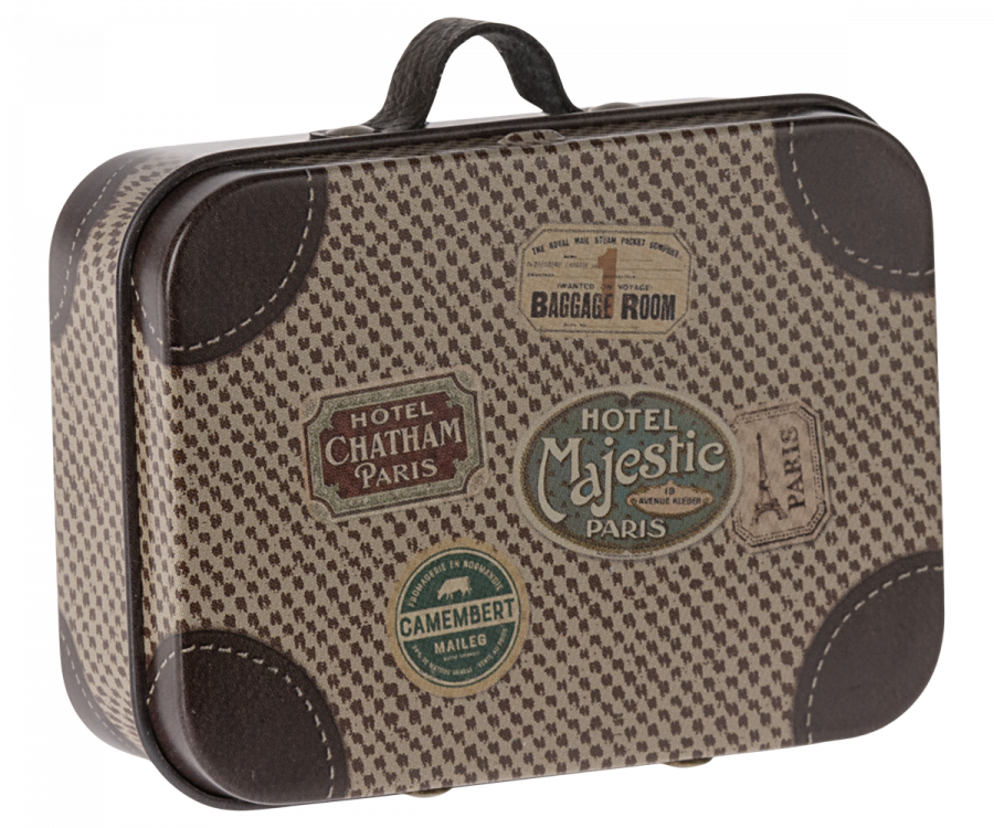 The Maileg Suitcase, Micro is a small rectangular piece with a vintage charm, showcasing a beige and brown checkered pattern. Decorated with an array of travel stickers such as "Hotel Majestic Paris," "Hotel Chatham Paris," and "Baggage Room," it is perfect for storing small items. The suitcase also features a black handle on top for easy carrying.