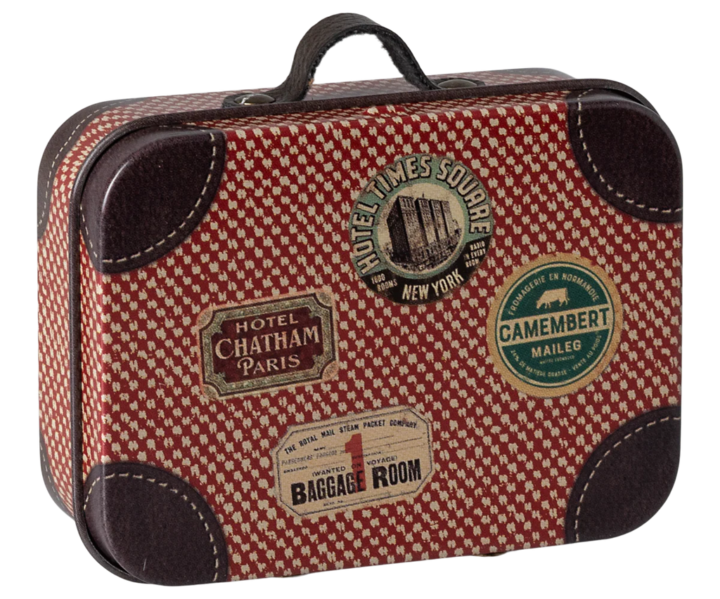 The Maileg Suitcase, Micro is a small metal case with a vintage red pattern, dark brown leather corners, and travel stickers—ideal for storing small items or as a charming gift presentation.