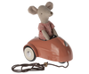 A Maileg Mouse Car - Coral wearing a red and white checkered shirt, seated in a miniature vintage-style metal car, with a pull-cord attached to the front.