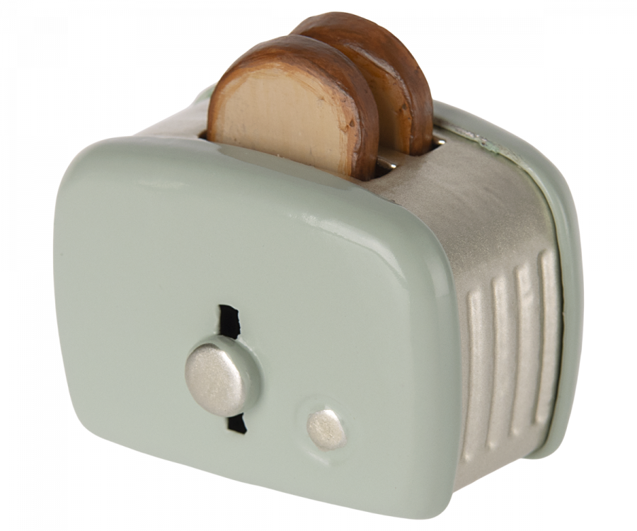 A Maileg | Miniature Toaster - Mint with two slices of toasted bread popping out, viewed from a slightly angled side perspective, emphasizing the toaster's dial and lever.