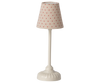 The compact table lamp features a white base and a fabric shade decorated with red polka dots against a beige background. Its vintage, minimalist design echoes the charm and simplicity of the Maileg Mouse Size Vintage Floor Lamp - Sand (With Battery) collection.