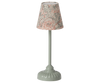 A table lamp with a mint base and a conical lampshade featuring a gray and orange floral pattern, offering soft tone lighting reminiscent of the Maileg Vintage Floor Lamp - Mint (Mouse Size).