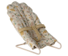 The Maileg Little Rabbit’s Nursery Set includes a small, fabric-covered bouncer chair with a floral print, beige safety strap, and simple metal frame.