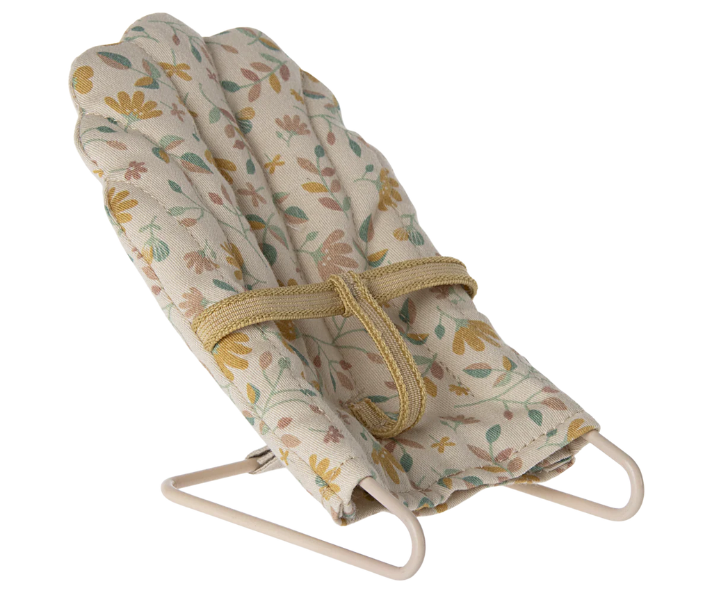 The Maileg Little Rabbit’s Nursery Set includes a small, fabric-covered bouncer chair with a floral print, beige safety strap, and simple metal frame.