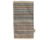 The Maileg Striped Rug, Large, is a rectangular woven cotton rug featuring horizontal stripes in earthy tones like brown, blue, and beige. Its fringe details along the edges make it an ideal door mat.