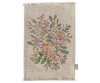 The Maileg Nursery Set includes a small rectangular woven rug with a central floral pattern, multicolored flowers, green leaves on beige, fringed edges, and a fabric tag—ideal for Maileg Miniatures or under the Maileg Mouse Closet.