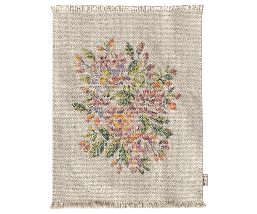 A beige woven rug with fringed edges and a colorful floral pattern, perfect for pairing with the Maileg Teddy Bedroom Set (ships in one week).
