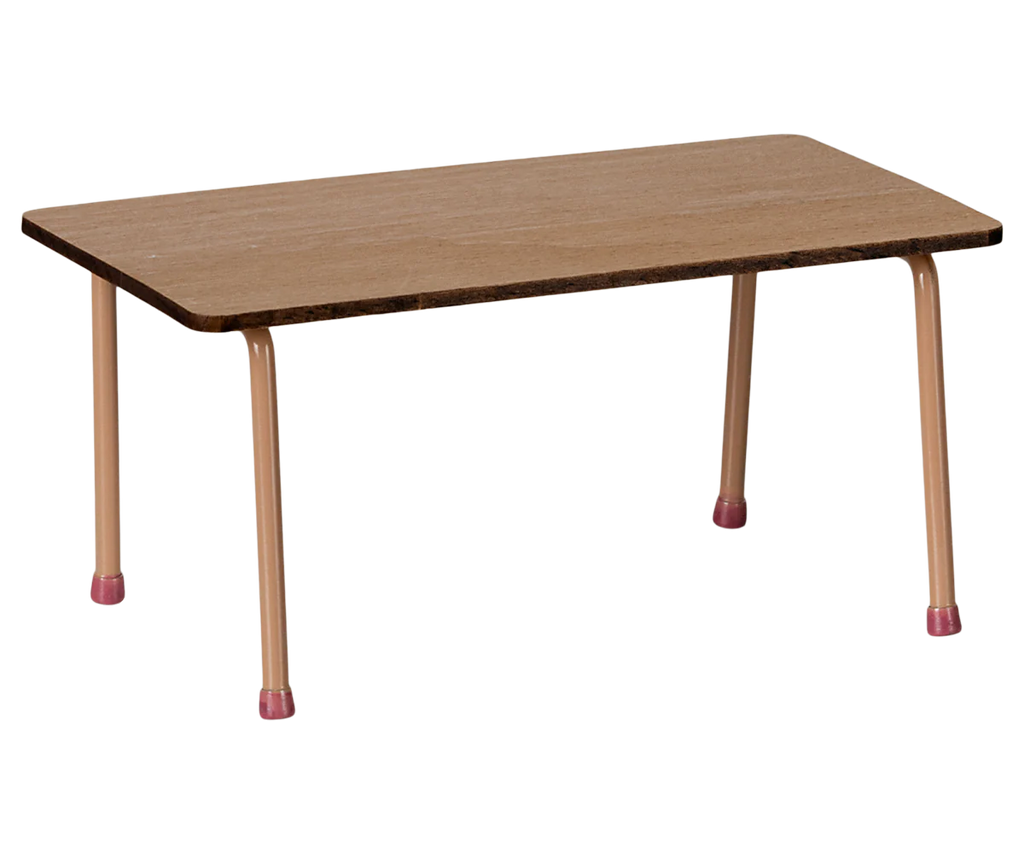 The Maileg School Table & Chair Set For Mice - Dark Powder is a simple rectangular table with a beech wood top, beige metal legs, and pink rubber feet. Ideal for a farmhouse aesthetic, the light wood grain finish enhances its charm. Ships in approximately one week.