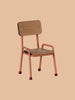 The Maileg Mouse Size School Chair in Coral features a hand-painted light brown wooden seat and backrest with copper-colored metal legs. Dark red caps adorn the legs, creating an elegant contrast against the plain beige backdrop. Ships in about one week.