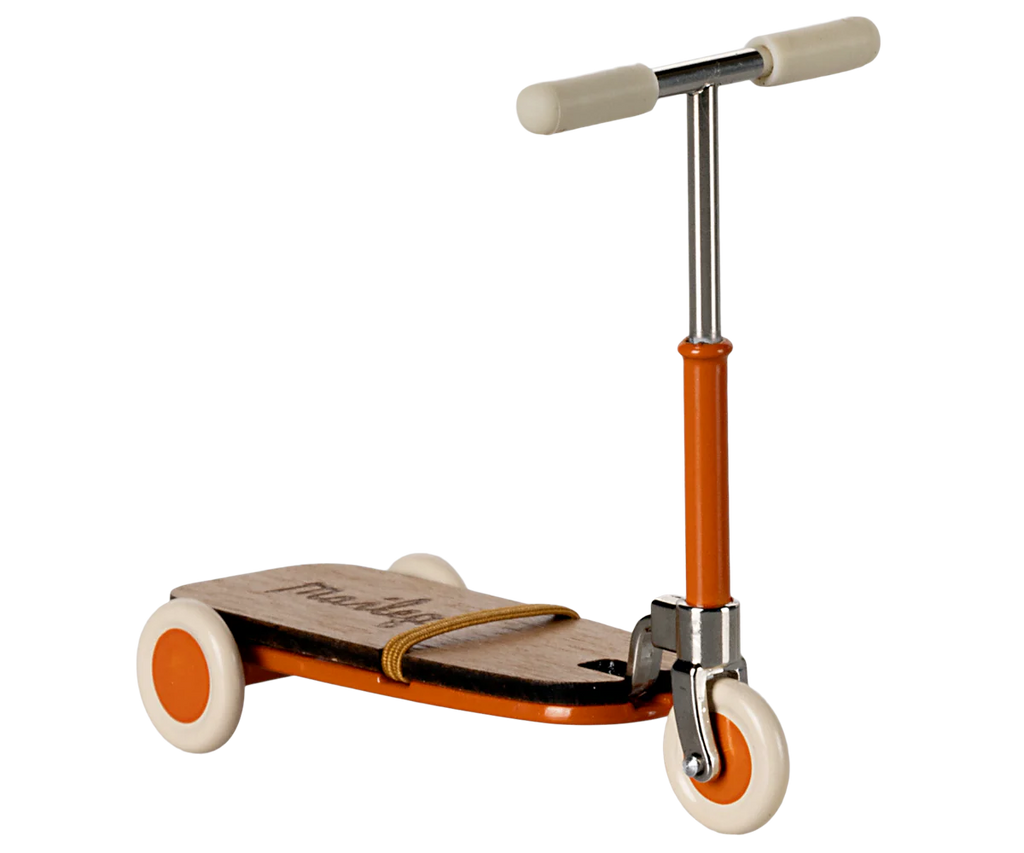 This charming kick scooter, ideal for a starter collection, features a wooden deck with "Moulin" printed on it. It boasts orange and white wheels, an orange frame, and cream handle grips—a delightful piece evoking the whimsical style of Maileg Little Sister Bedroom Starter Set.