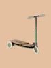 The Maileg Mouse Size Scooter / Kickboard features a minimalist design with elegant wooden details, including a wooden deck, mint green handlebars, and green and white wheels, set against a beige background. Ships in approximately one week.