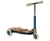 The Maileg Mouse Size Scooter / Kickboard - Blue boasts a wooden deck, blue metal frame, and white wheels. T-shaped handlebars with cream grips are elegantly secured by a tan rubber band. Shipping in approximately one week.