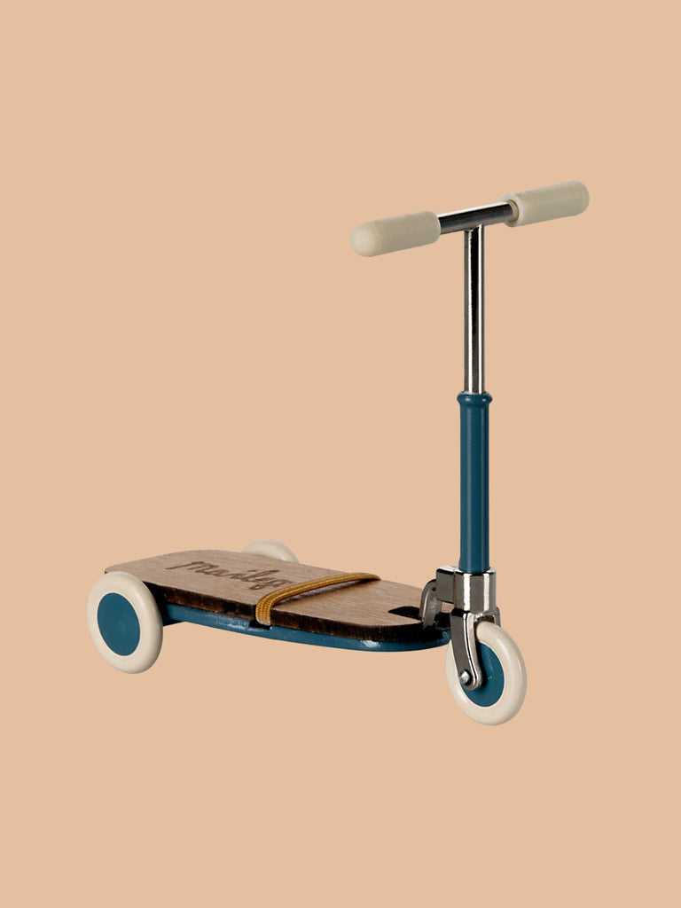 The Maileg Mouse Size Scooter/Kickboard is a vintage-style, three-wheeled scooter with wooden details, featuring a brown deck, blue frame, and white wheels and handlebars against a beige background.