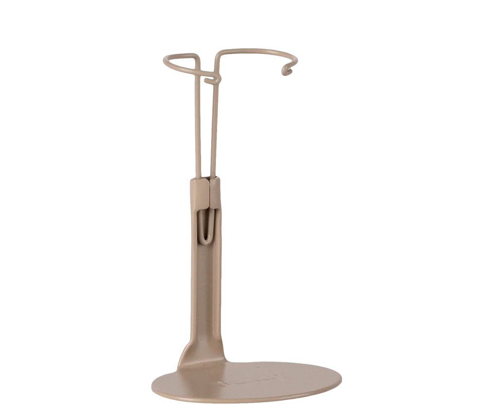 The Maileg Big Sister Getting Ready Set features a beige, minimalist Mouse Stand with a circular base and curved wire loop, ideal for keeping your Maileg Mouse upright.
