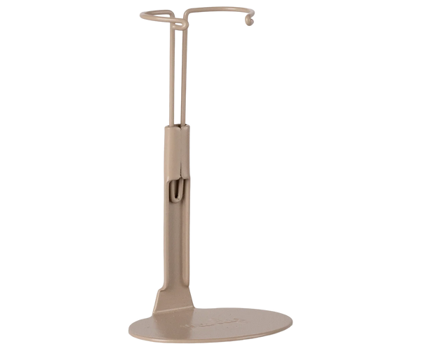 The Maileg Mouse Stand, Medium - Sand is a beige metal stand with a flat oval base and upright support ending in a circular hook, perfect for displaying your collection of headphones or similar items.