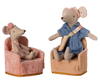 Two Maileg mouse toys sit on soft beige plush chairs adorned with gold-trim accents. The left mouse wears a pink dress and headband, while the right wears blue with a pink and yellow sash. Resembling a cozy farmhouse corner, both chairs are the PRE-ORDER: Maileg Soft Chair - Rose.