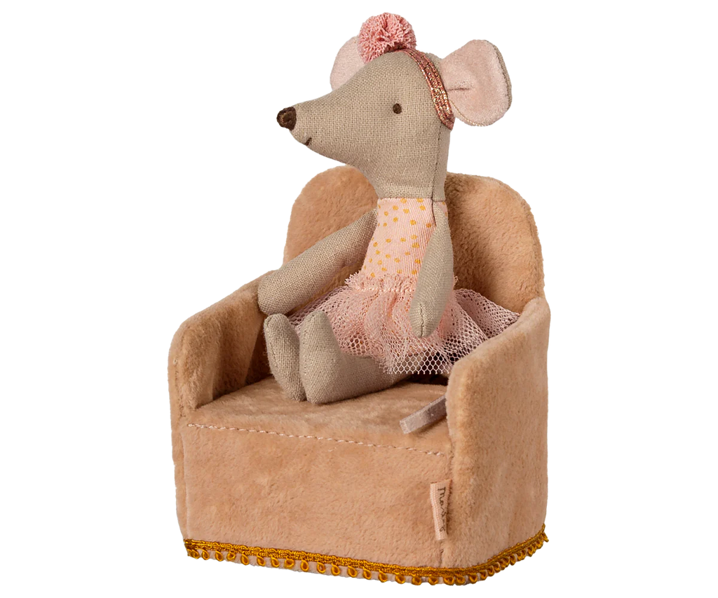 A light gray mouse in a polka dot top, pink tutu, and floral headband from the Maileg friends collection sits on the Maileg Soft Chair - Powder (ships late February), a small, soft light brown armchair adorned with gold fringe.