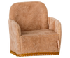 The Maileg Soft Chair - Powder is a small, plush armchair with light brown fabric and a boxy design featuring a rounded backrest, armrests, and decorative gold trim, perfect for your Maileg friends. Available for pre-order, it ships in late February.