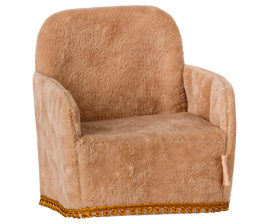 The Maileg Soft Chair - Powder is a small, plush armchair with light brown fabric and a boxy design featuring a rounded backrest, armrests, and decorative gold trim, perfect for your Maileg friends. Available for pre-order, it ships in late February.