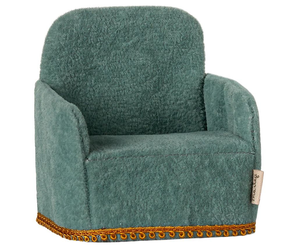 The PRE-ORDER: Maileg Soft Chair - Mint, shipping in late February, is a cozy miniature armchair made for Maileg friends. It features soft green fabric with a slightly curved backrest and armrests and intricate gold trim for an elegant touch, typical of small Maileg furniture.