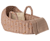 The Maileg Carry Cot, Large - Rose features a pink quilted design with floral patterns, two handles, a star pillow, and a beige knitted blanket—ideal for carrying small plush friends wherever you go.