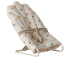 The Maileg My Babysitter - Multi Dots features a soft cotton seat with multicolored polka dots, padded comfort, a secure fabric strap, and a sturdy white metal base—perfect for small dolls or pretend play.