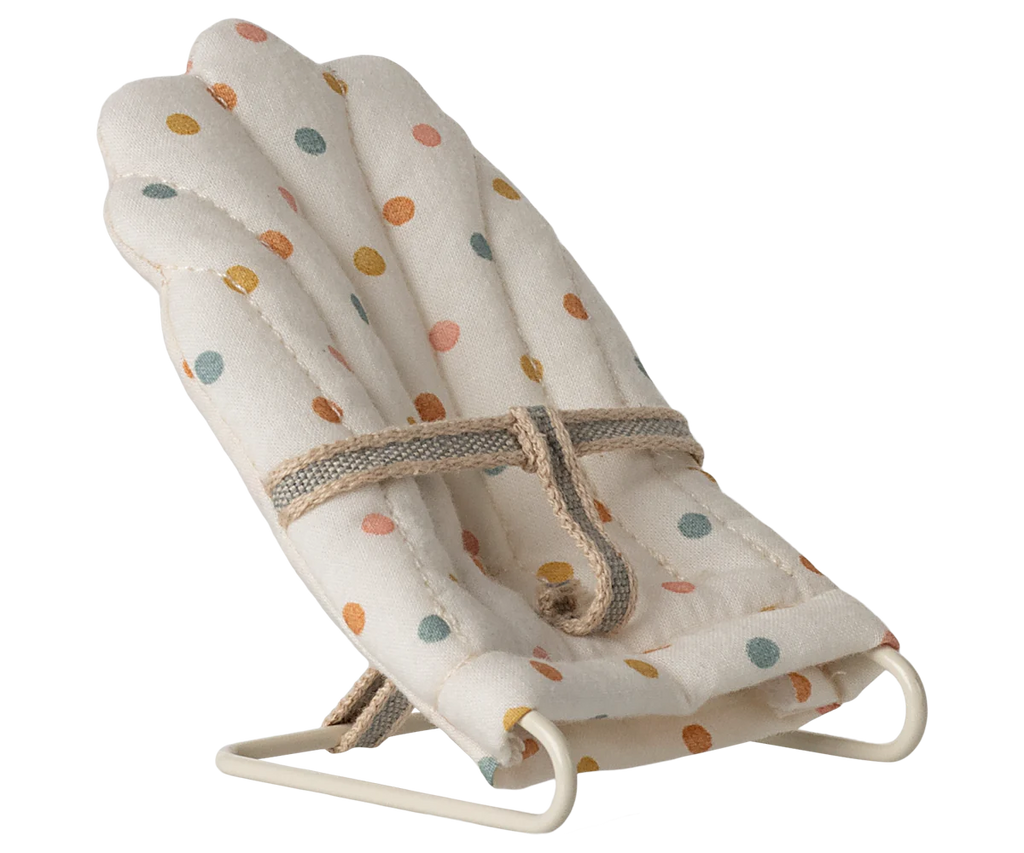 The Maileg My Babysitter - Multi Dots features a soft cotton seat with multicolored polka dots, padded comfort, a secure fabric strap, and a sturdy white metal base—perfect for small dolls or pretend play.