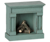 The PRE-ORDER: Maileg Fireplace, Mouse - Blue (Estimated Arrival Mid August) is a charming, vintage-style decorative fireplace with faux logs, perfect for adding cozy appeal to your miniature home.