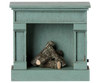 The PRE-ORDER: Maileg Fireplace, Mouse - Blue (Estimated Arrival Mid August) is a charming, vintage-style wooden fireplace in blue with realistic fake logs—an ideal addition to any miniature home décor.