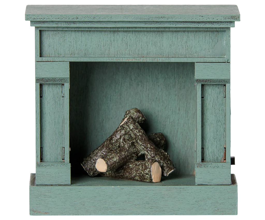 The PRE-ORDER: Maileg Fireplace, Mouse - Blue (Estimated Arrival Mid August) is a charming, vintage-style wooden fireplace in blue with realistic fake logs—an ideal addition to any miniature home décor.