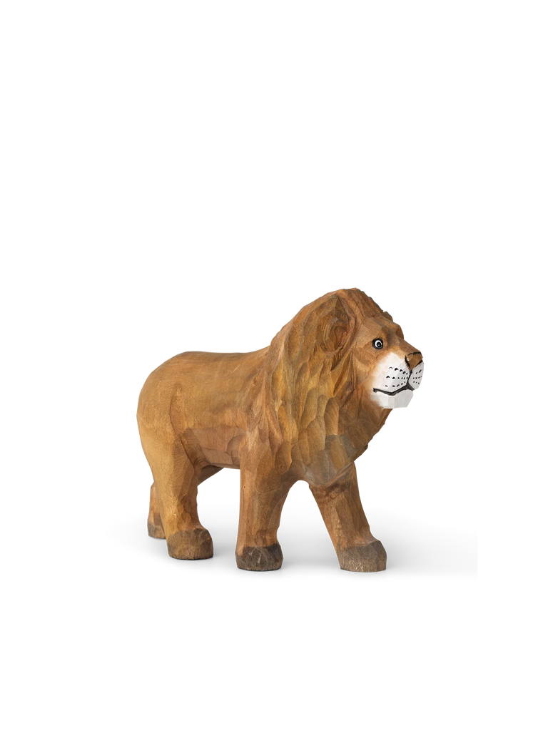 A Hand Carved Wooden Lion, sculpted with visible texture and details in the mane, standing against a simple white background with mild shadow under it.