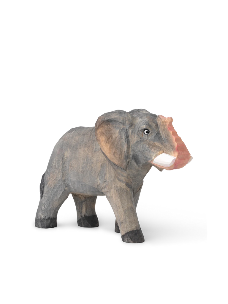 A Hand Carved Wooden Elephant with a blurred, stretched background effect on one side, standing isolated on a white backdrop.