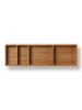 A Ferm Living Bon Shelf - Oiled Oak with four compartments, two with sliding doors, crafted from oiled oak, against a black background.