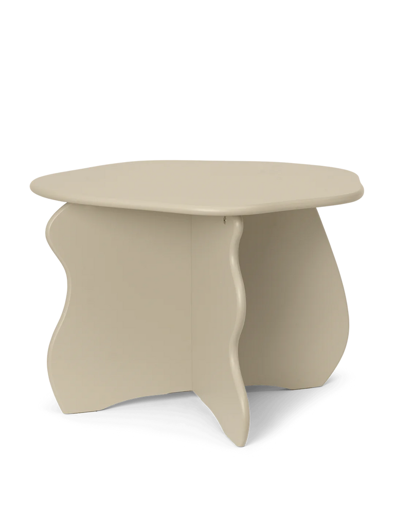 A modern cashmere-colored coffee table with an abstract base design, isolated on a black background, made from FSC™ certified MDF.