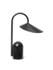 The Ferm Living Arum Portable Lamp in Black features a modern curved arm, wide angled shade, cylindrical base, and touch dimmer. This rechargeable lamp’s minimalist design adds contemporary style and convenience to any space.