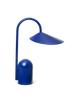 The Ferm Living Arum Portable Lamp in blue features a curved stem and wide, slanted shade on a rounded cylindrical base, shown against a plain white background.