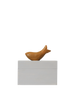 The Ferm Living Hand Carved Wooden Harbour Box - Fish features a small, fish-shaped wooden figure with a hand-carved handle resting on a rectangular light gray block, set against a plain black background.