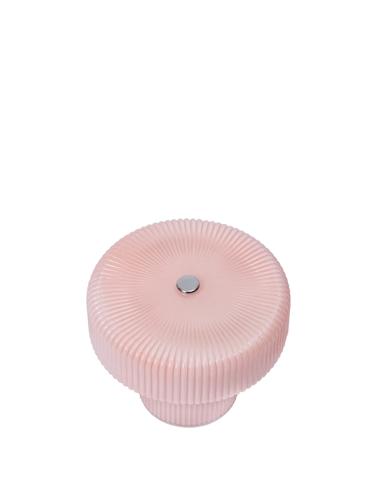 The Ferm Living Ripple Portable Lamp in Pale Rose features round, ribbed, light pink mouth-blown glass with a flat lid and a small silver knob on top, displayed against a plain white background.