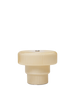 The Ferm Living Ripple Portable Lamp - Oat is a cream-colored, ribbed cylindrical lamp with a wide flat top, a narrower base, mouth-blown glass construction, dimmable LED light, and is shown against a plain white background.