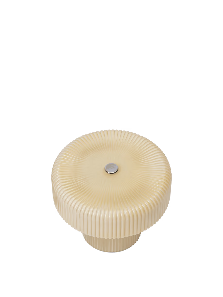 A round, oat-hued ribbed object with a metallic center—resembling the base of the Ferm Living Ripple Portable Lamp - Oat—rests on a plain white background.