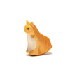 The Ostheimer Orange Cat, Sitting is a small, handcrafted wooden figurine depicting a cat with orange and white fur. This cat features an upright posture, green eyes, and a content expression. Set against a plain white background, the figurine becomes the central focus of the image. Ideal for imaginative play.