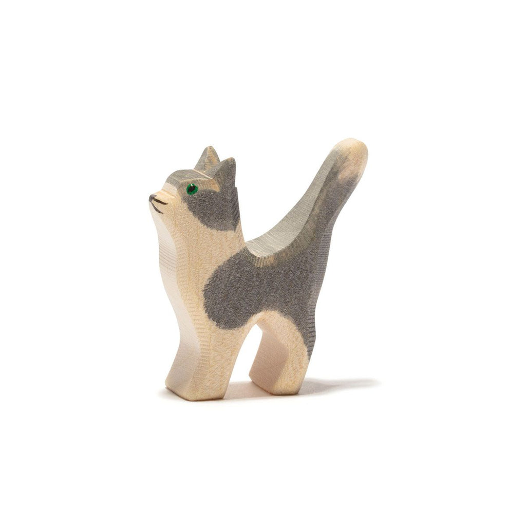 Introducing the Ostheimer Gray and White Cat, Head Up. This handcrafted wooden toy figurine, with its tail raised high, features a charming mix of gray and natural wood tones, along with green painted eyes. Its smooth, simple design makes it perfect for imaginative play and adds a touch of charm to any collection.