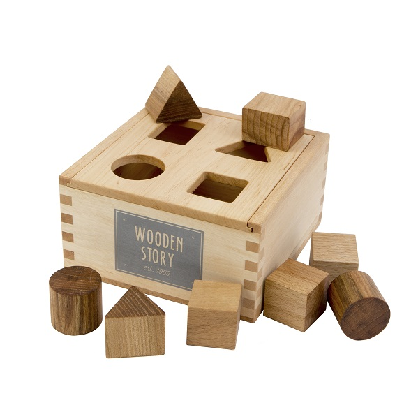 The Natural Shape Sorter Box, crafted from eco-friendly materials, includes geometric figures such as cubes, cylinders, and triangles—some slot into matching holes atop the box, while others can be arranged around it.