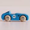 A small blue wooden race car—the No. 5 GT30 Coby, made in England—with the number 93 on its side and wooden wheels, photographed against a plain light background. This classic racing toy blends timeless design with sustainable English craftsmanship for endless imaginative play.