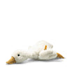 The Steiff XL Gilda Goose is a white plush stuffed animal with a yellow beak and feet, lying on its stomach. Soft and fluffy, it features a small orange tag on its wing—perfect for cuddling against a plain white background.