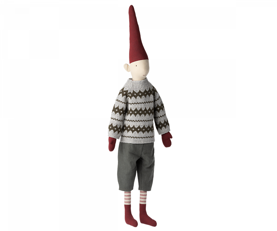 A Maileg Christmas Mega Pixy (Size 6) with a long red pointy hat, wearing an exclusive materials grey sweater with a white and black pattern, grey shorts, and striped socks, isolated on a black background.