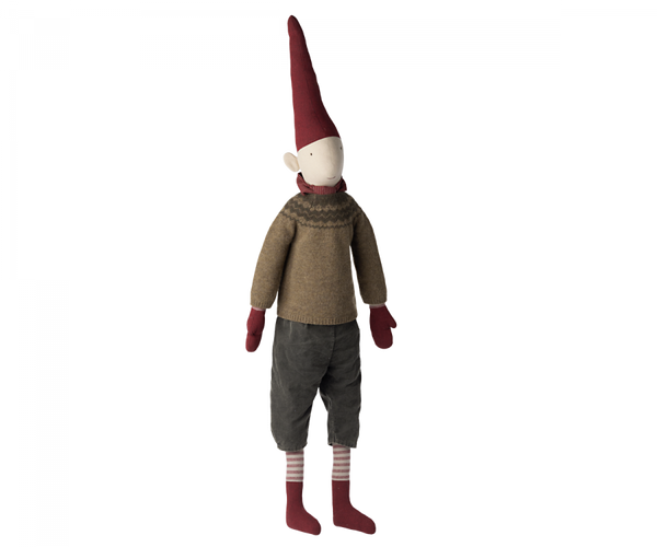 A Maileg Christmas Mega Pixy - (Size 6) with a red pointed hat, white face, brown sweater, grey pants, and striped socks, standing isolated against a plain background as a Christmas decoration.