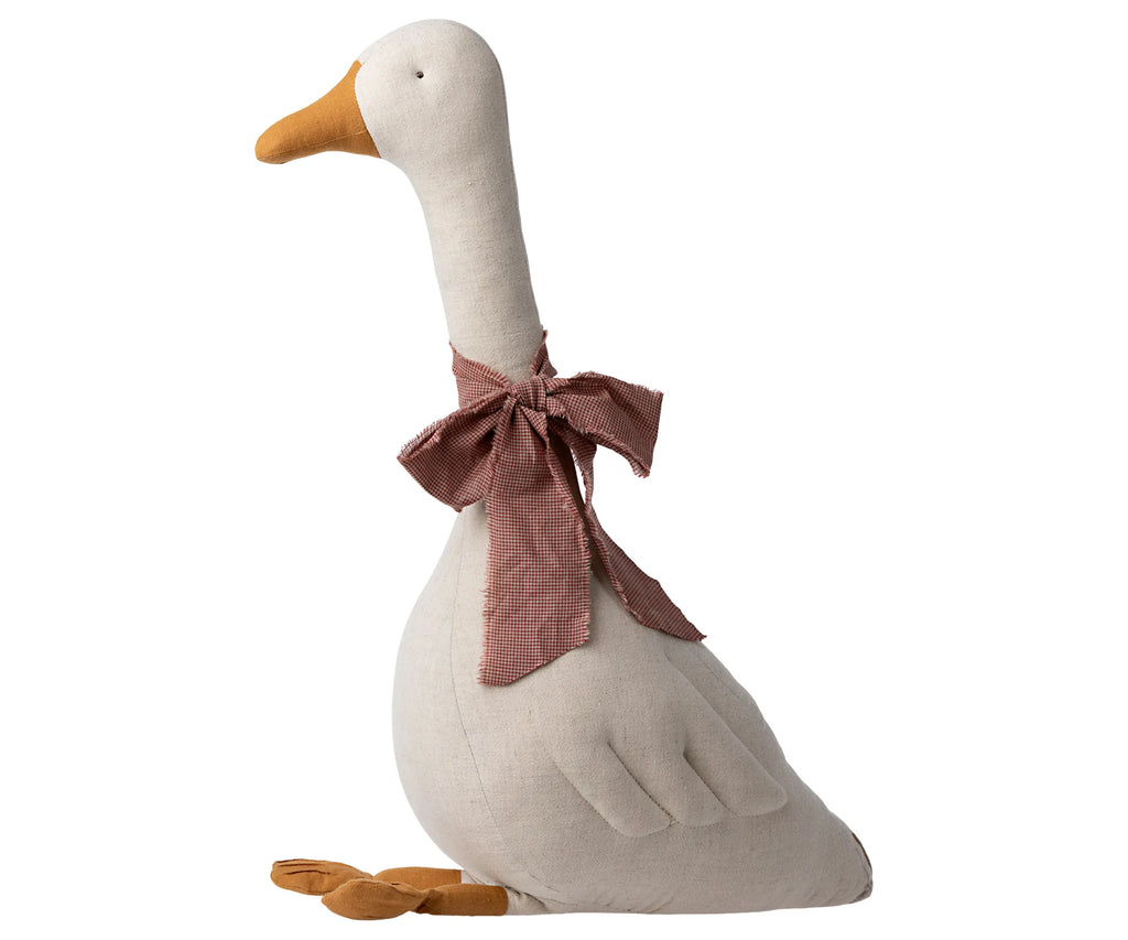 A Maileg Large Goose made of fabric with a checkered bow around its neck, standing upright against a white background. The goose is light beige with orange feet and beak.